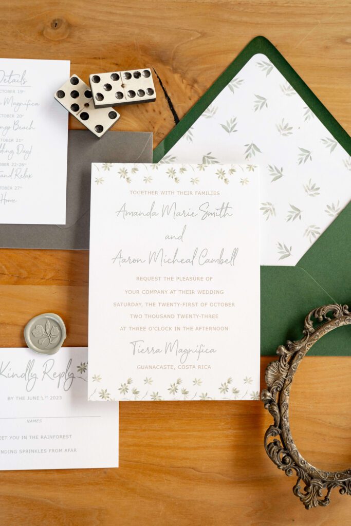 Costa Rica destination wedding invitations with tropical watercolor florals and a green envelope