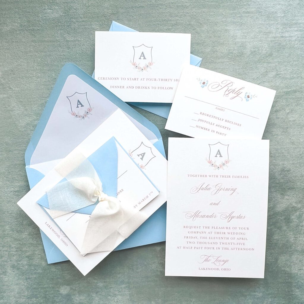 Elegant blue and white wedding invitation suite with custom floral monogram