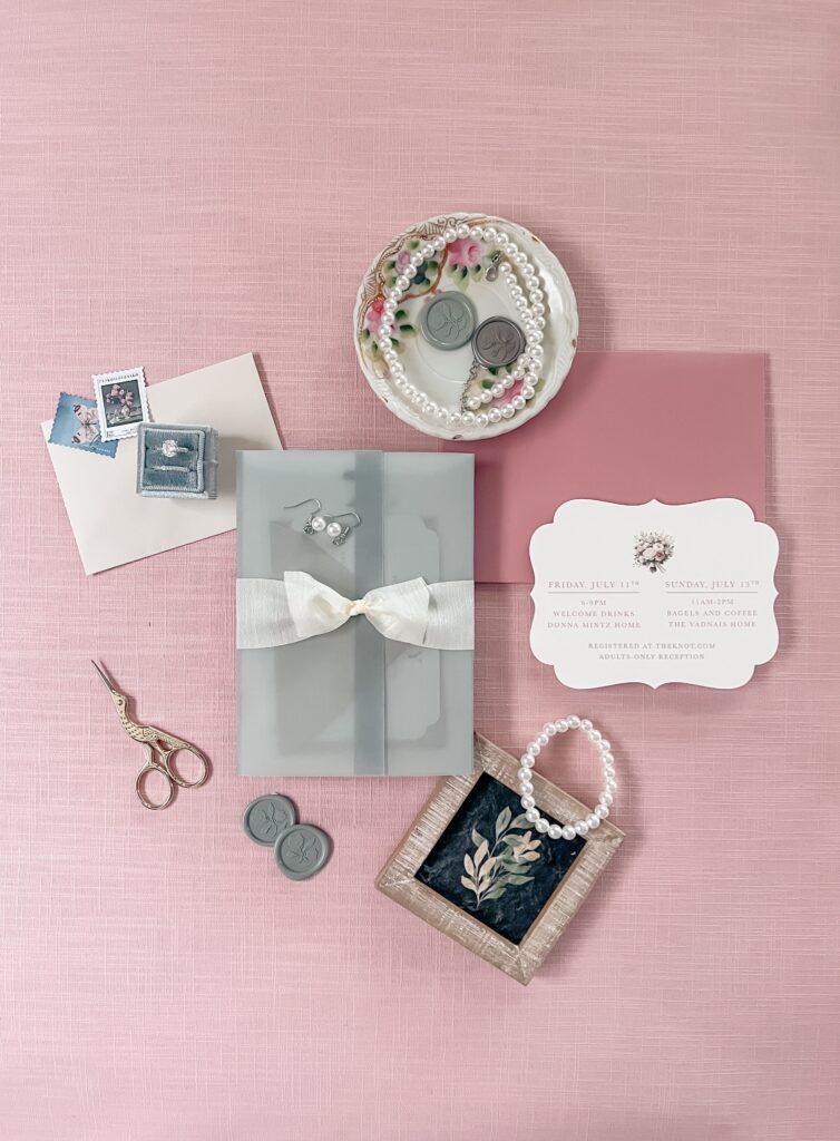 Wedding invitation suite featuring a vellum overlay and silk ribbon