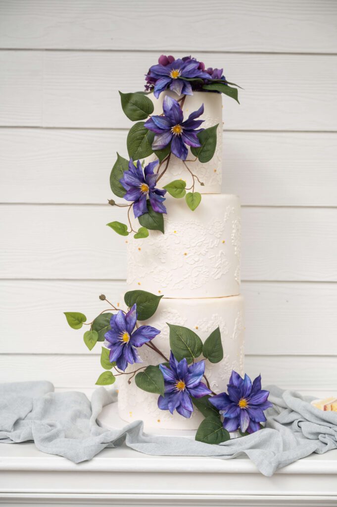 Elegant wedding cake decorated with purple flowers