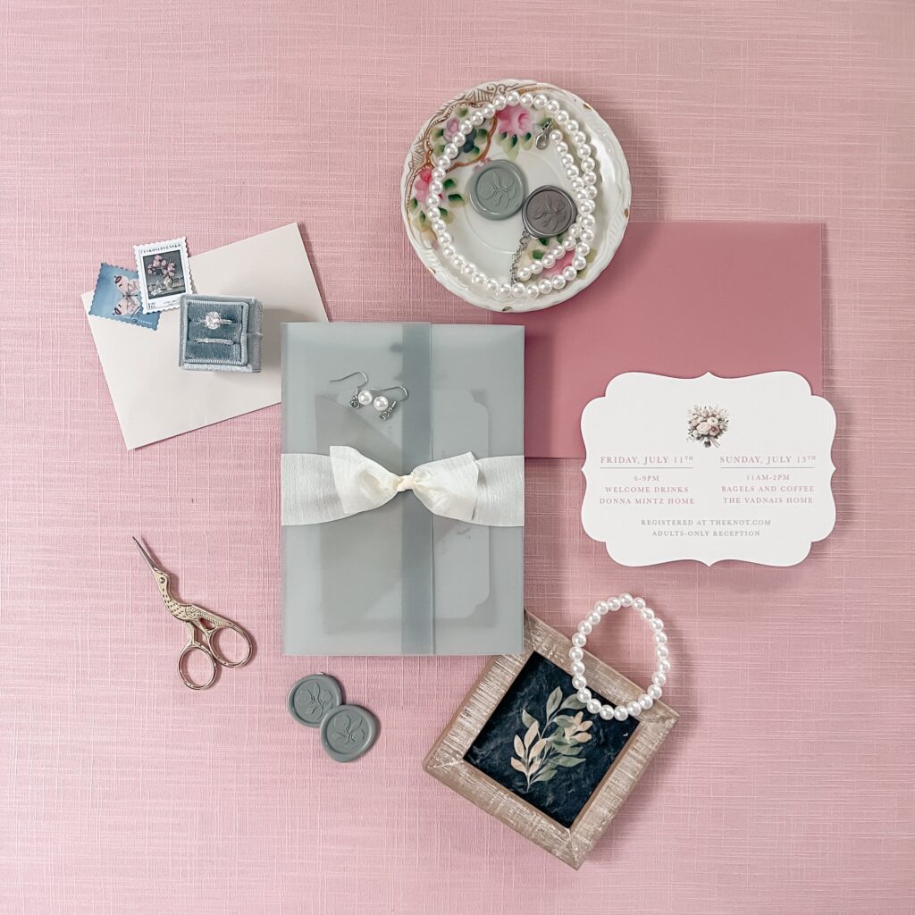 Wedding invitation suite with embellishments of custom postage, vellum, and die-cut card