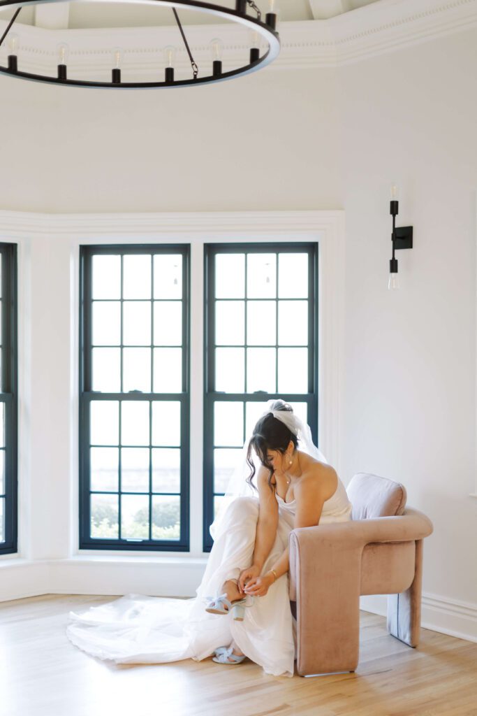 Bride puts on shoes in Basil Place's bridal suite