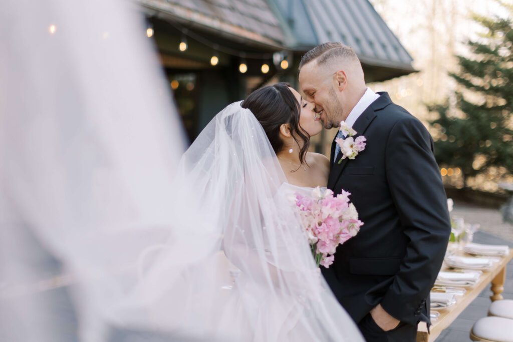 Bride and groom kissing at Basil Place wedding reception