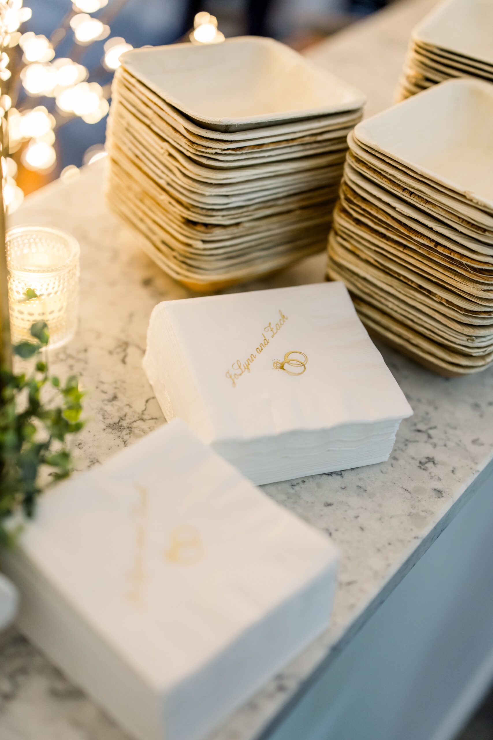 White and gold foil cocktail napkins that read "JoLynn and Zack"