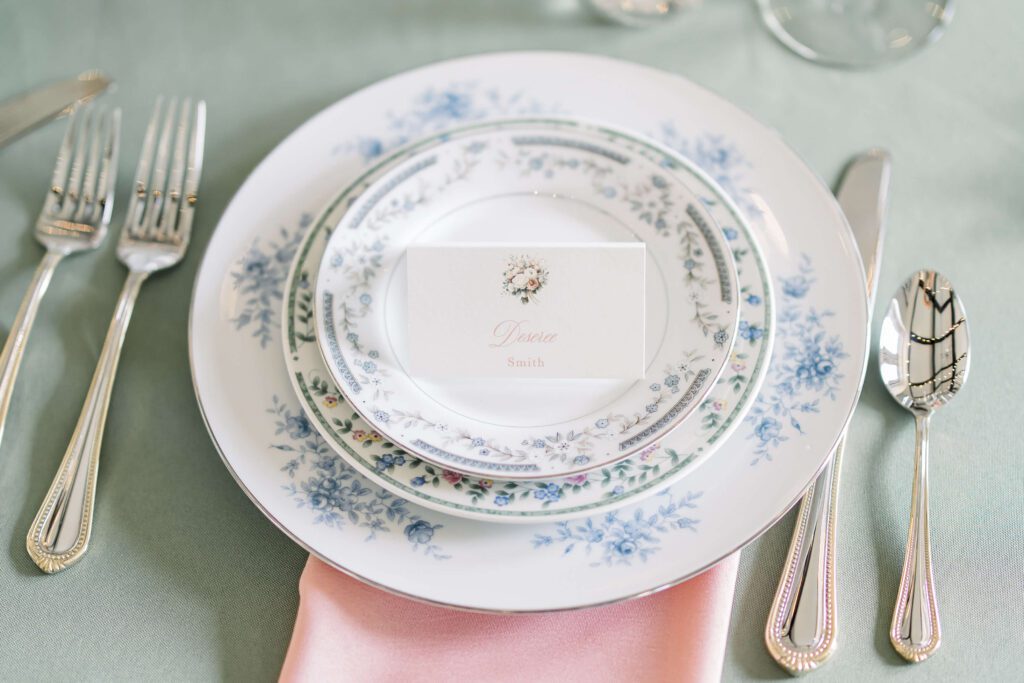 Elegant tented place card sitting on vintage china