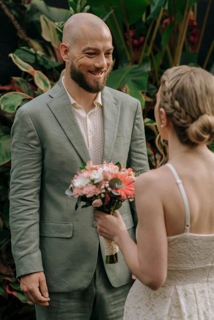 Groom smiling at bride during their first look