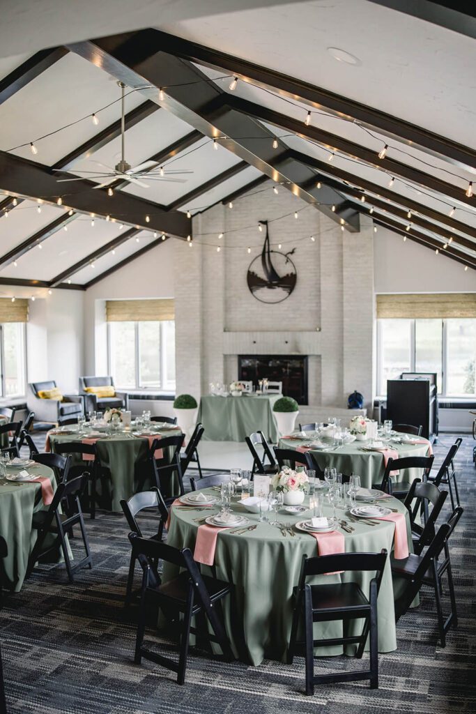 Micro wedding reception venue decorated in an elegant green and blush color scheme