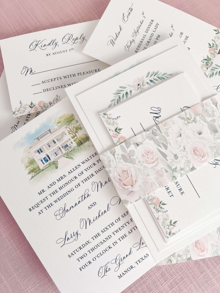 Wedding invitation suite with watercolor floral details and venue artwork