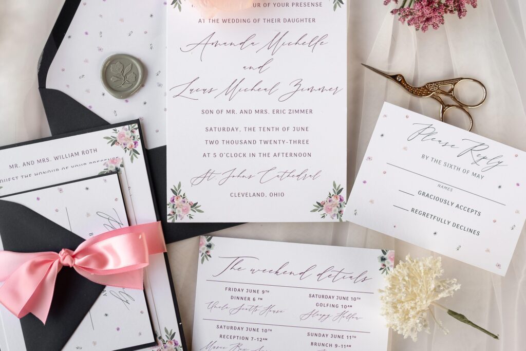 Whimsical garden wedding invitations in pink and black with floral details