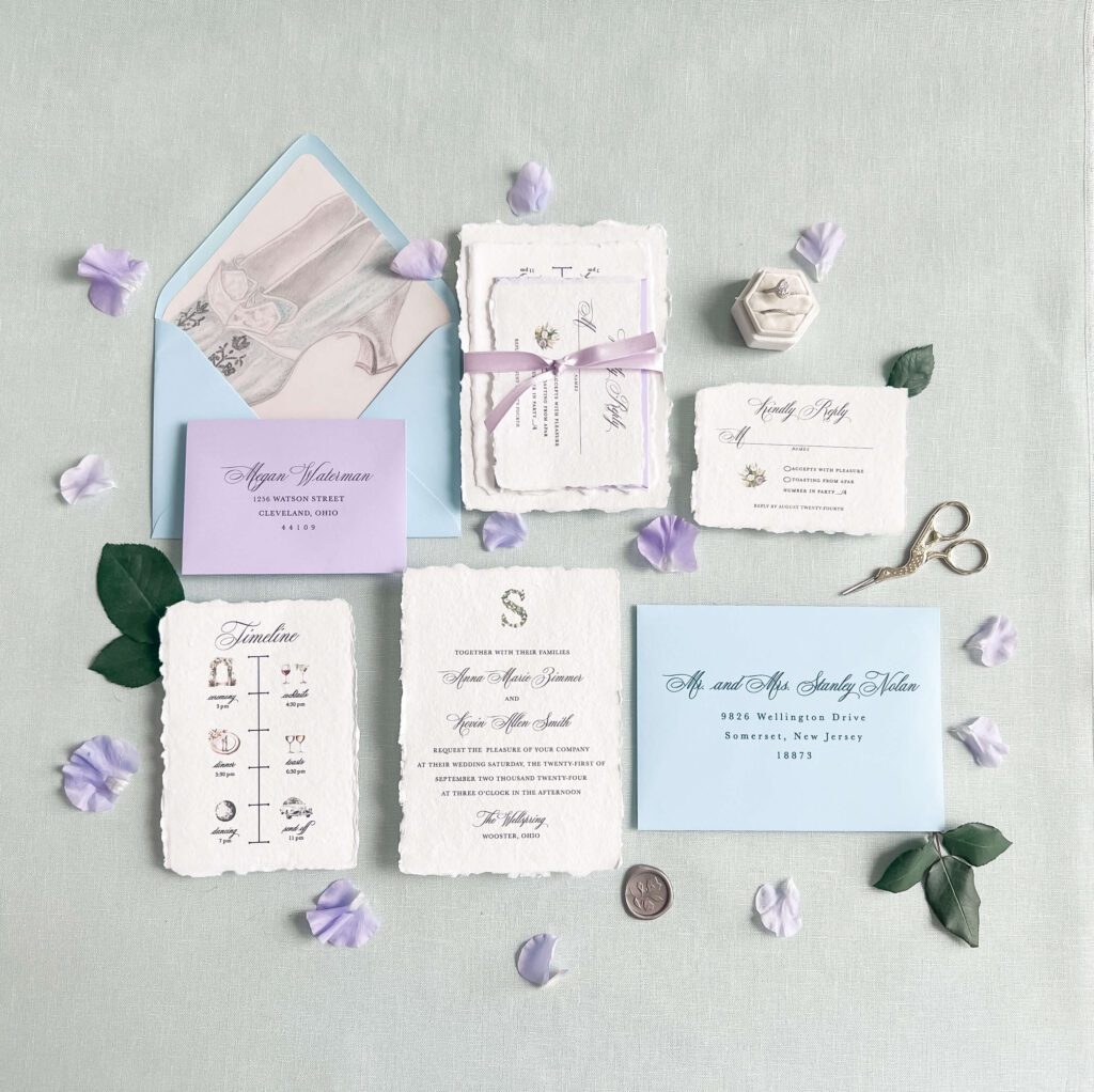 Purple and blue wedding invitation suite with deckled edge paper and watercolor artwork