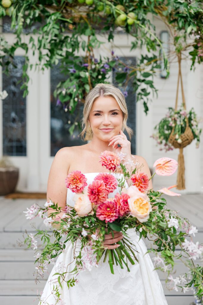 Bride with whimsical bouquet in blush, peach, and pink
