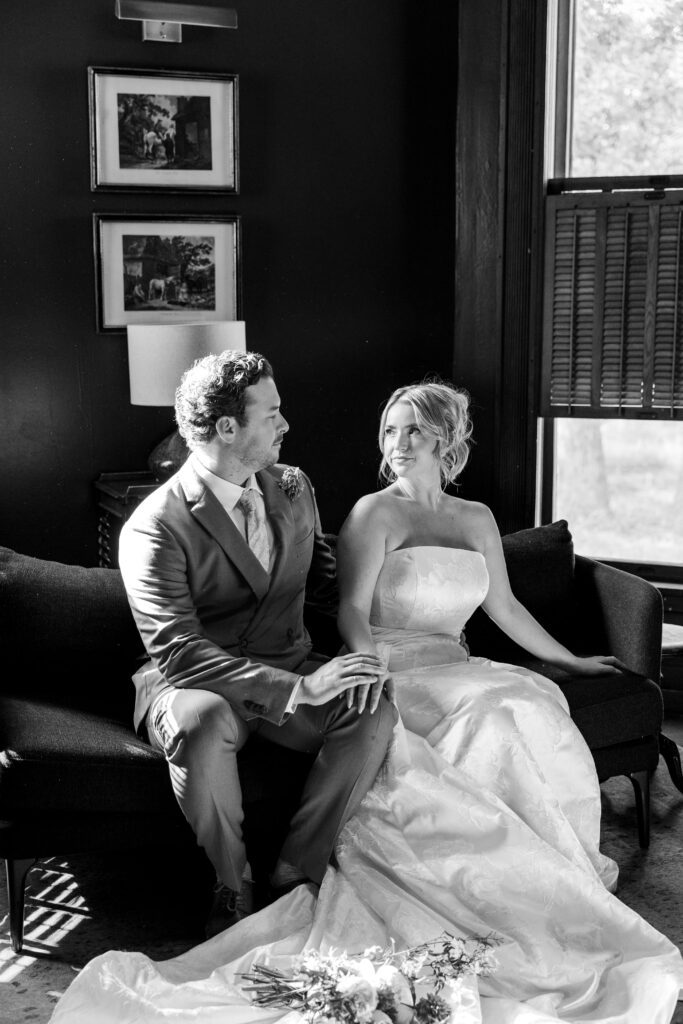 Moody candid of bride and groom in a study