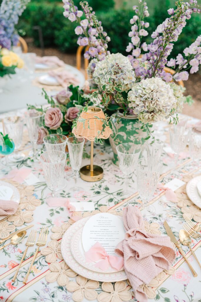Die-cut wedding invitation card with a pink bow on an elegant reception table