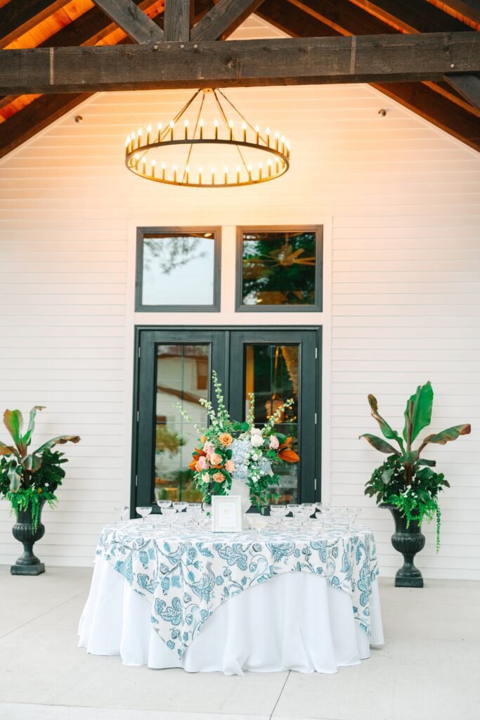Champagne welcome table with light blue and ivory tablecloth