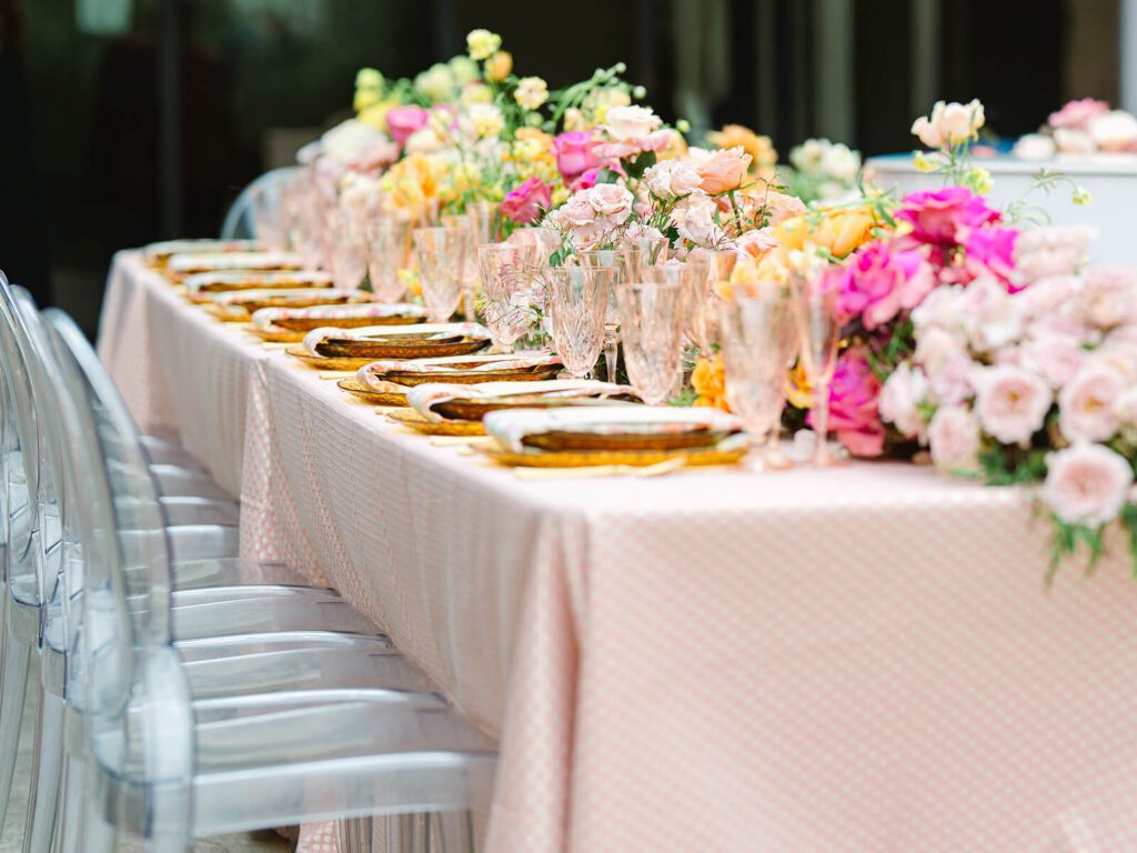 Pink and orange wedding reception table for a garden party wedding
