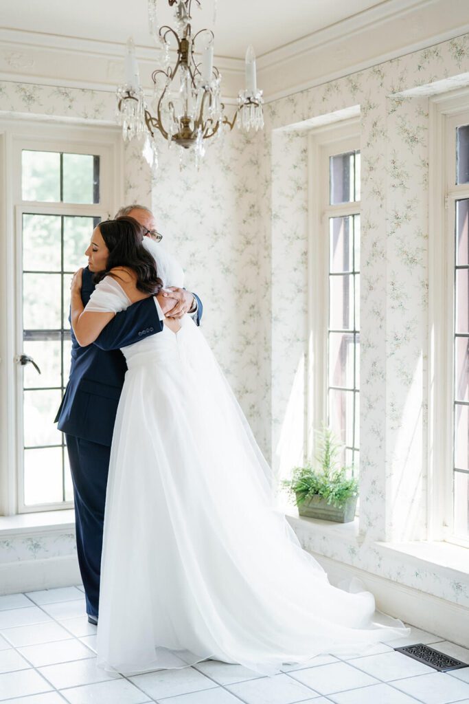 Bride hugging her father the morning of her wedding at Tudor House