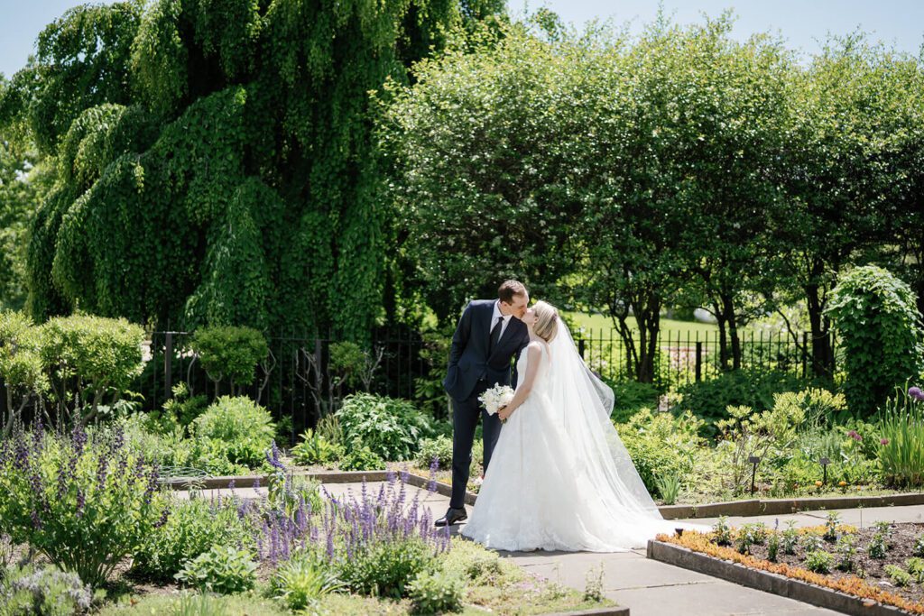 Bride and groom kissing after their wedding ceremony in the Cleveland Botanical Garden