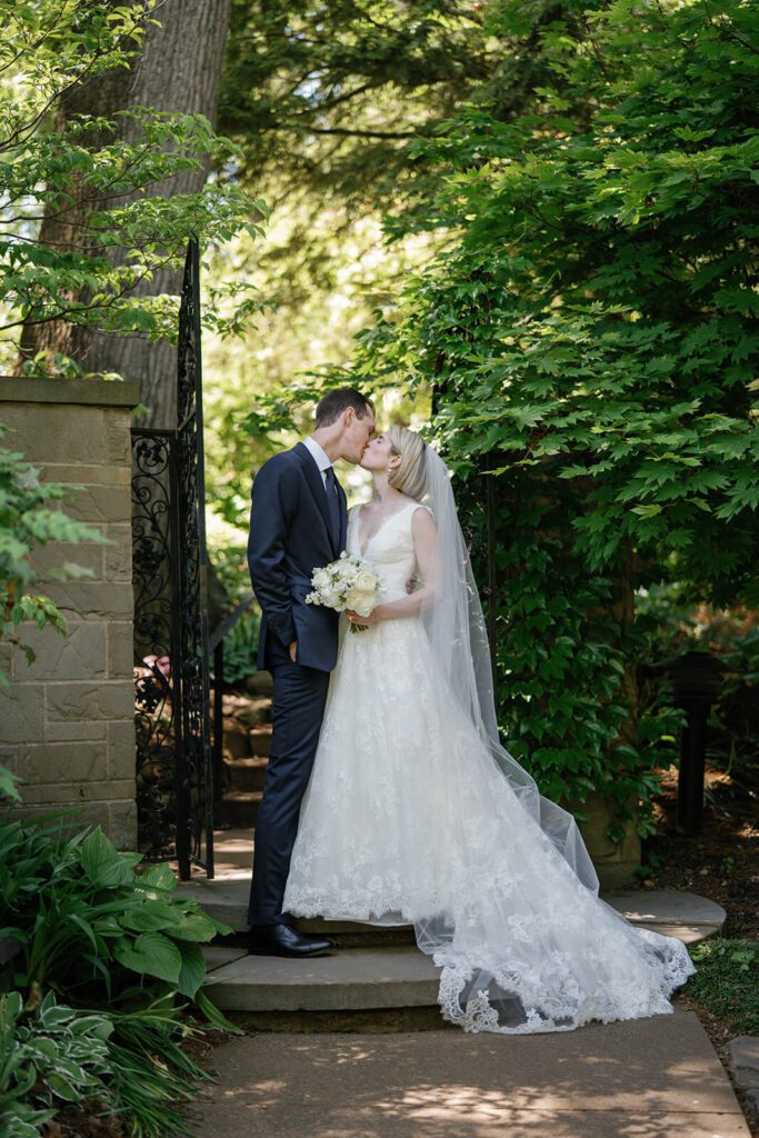 Bride and groom kissing in the Cleveland Botanical Garden