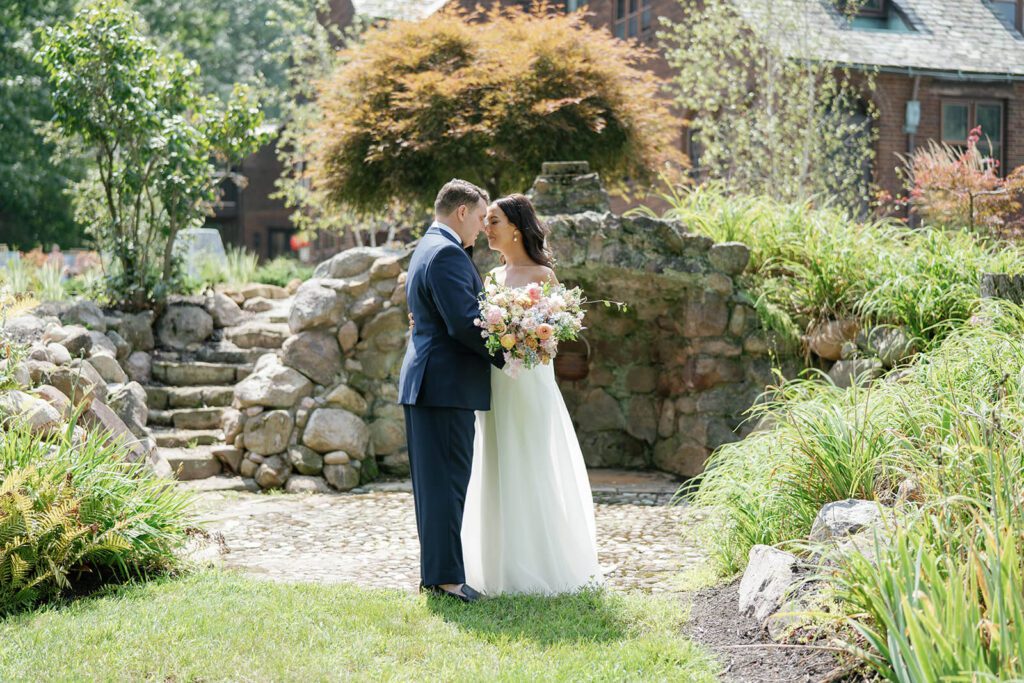 Bride and groom candid photo in the gardens at Tudor House