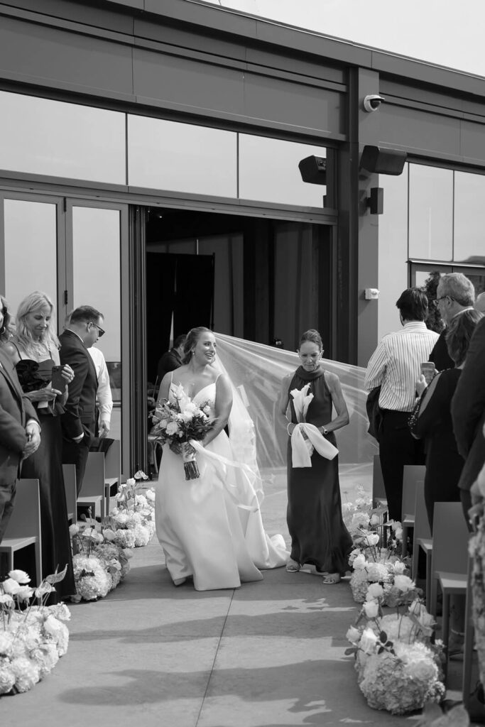 Bride escorted down aisle on the rooftop of Truss