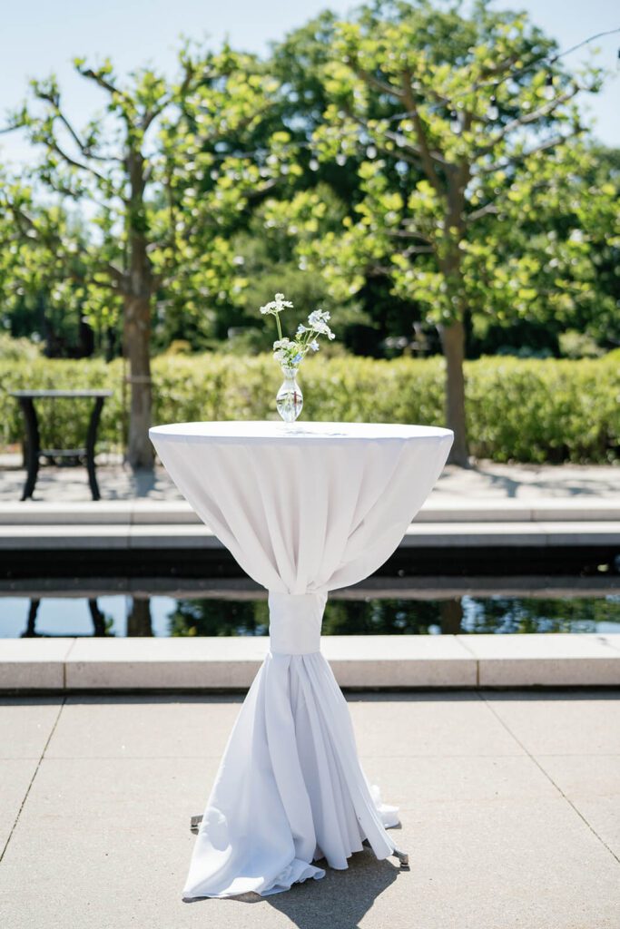 Elegant white cocktail table outdoors at the Cleveland Botanical Garden