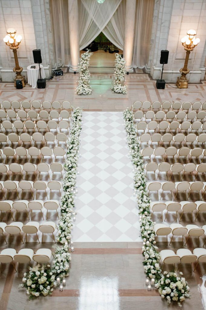 Elegant white and gold chairs set up for a wedding ceremony in The Old Courthouse in Cleveland