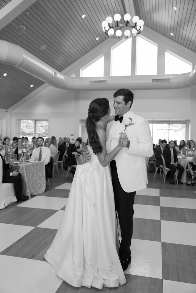 Bride and groom ballroom dance on a checkered dance floor