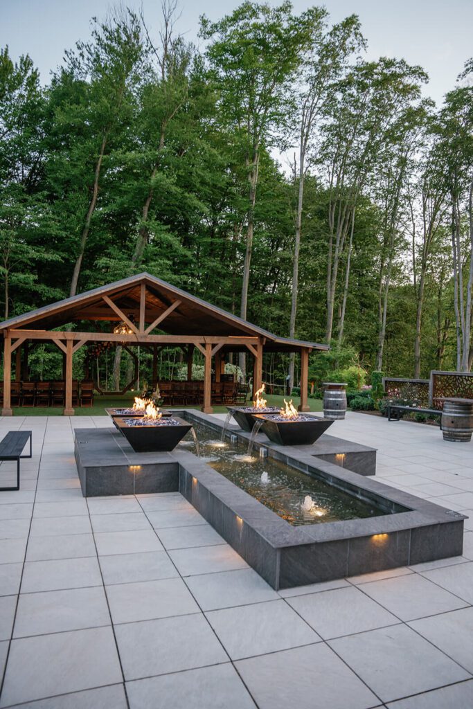 Patio at Sapphire Creek Winery, with a water feature and decorative fireplaces