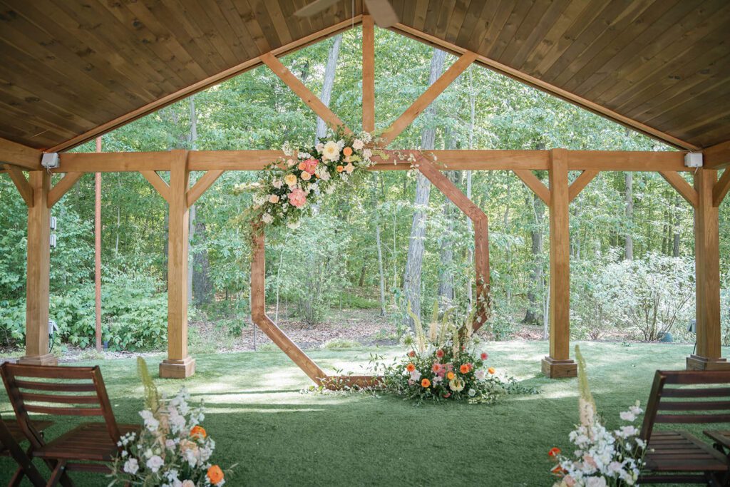 Rustic wedding ceremony octagon under an outdoor pavilion at Sapphire Creek Winery