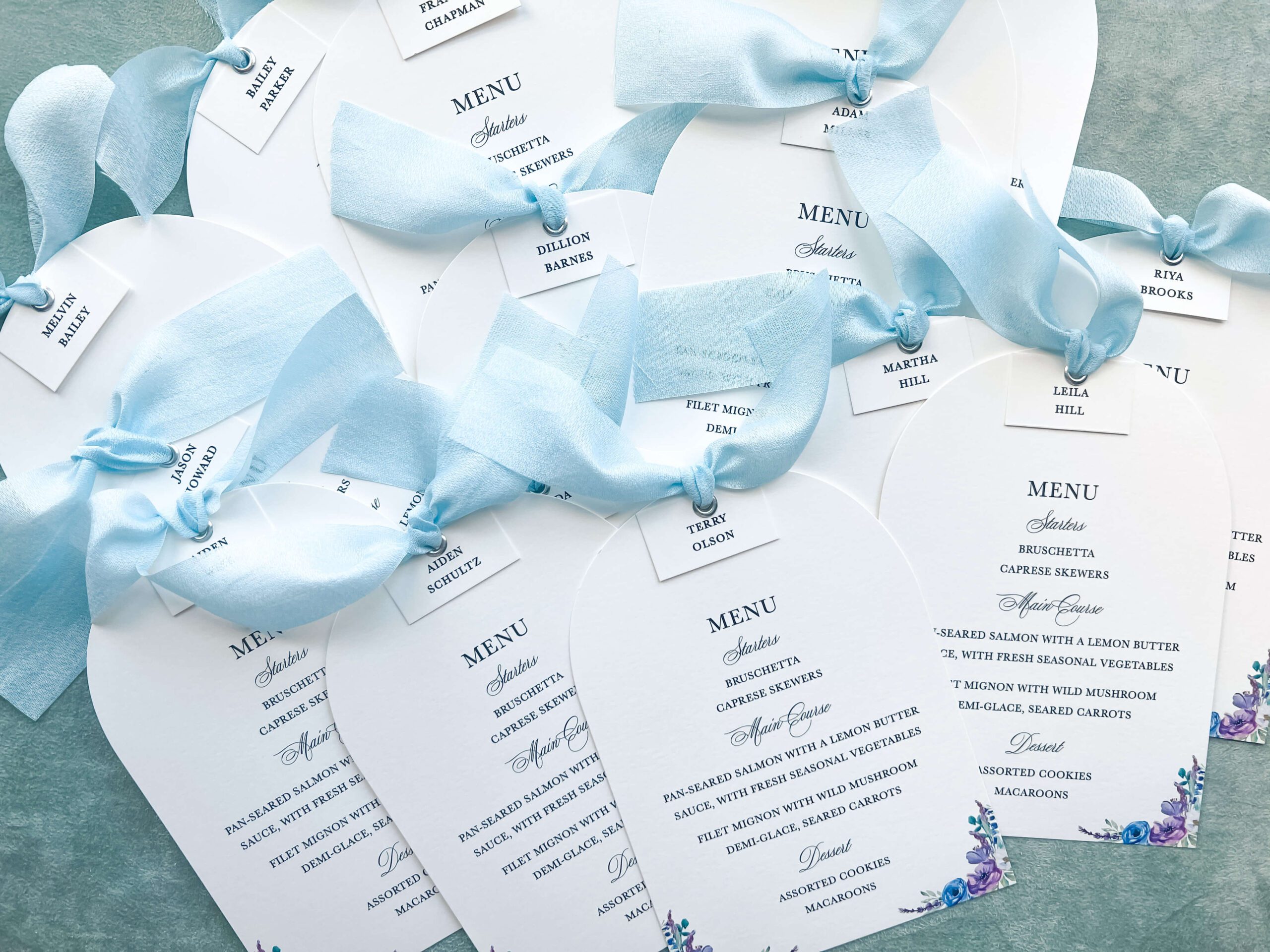 Die-cut wedding menus and place cards with blue bows