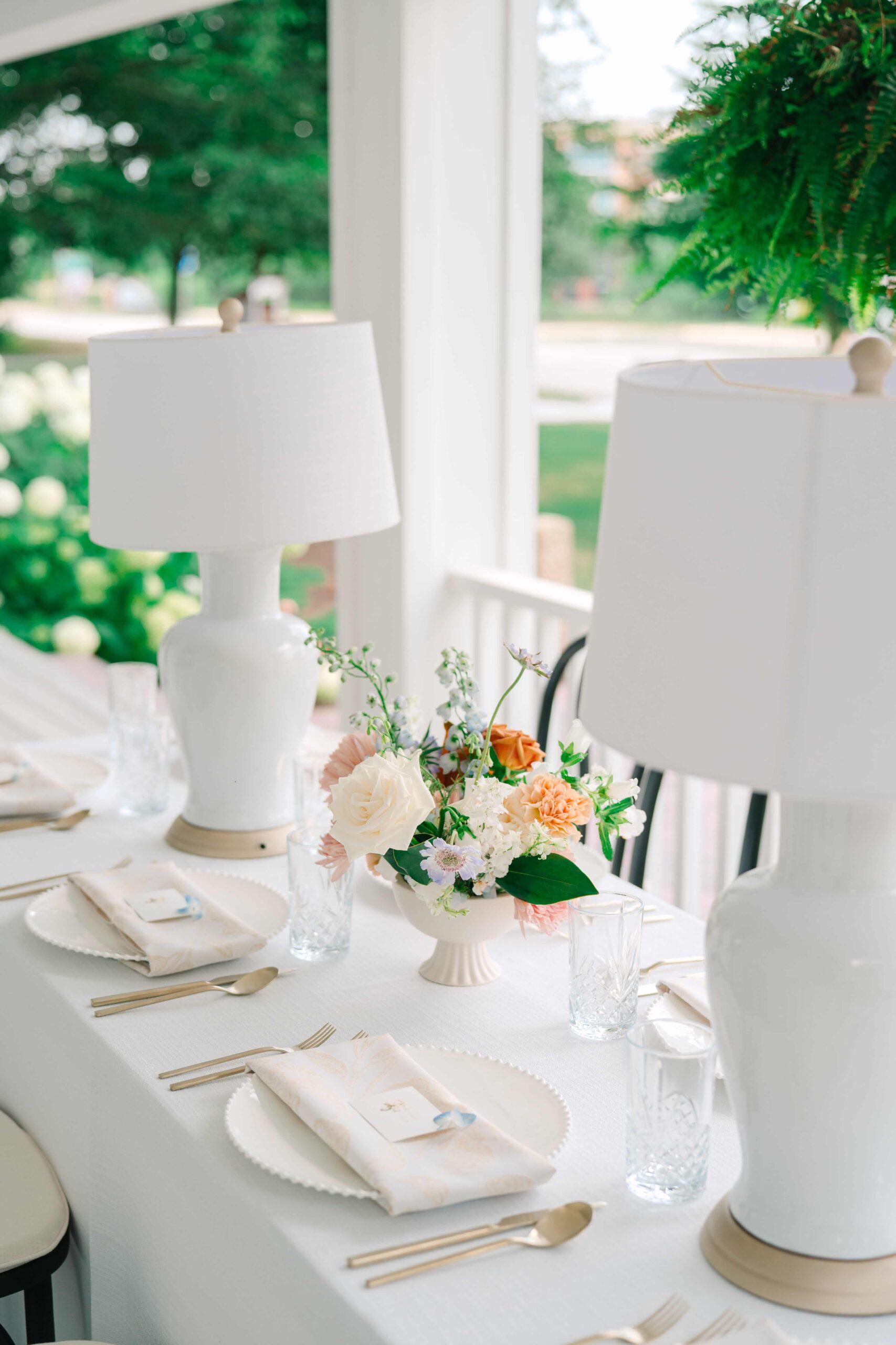 Elegant tablescape on the porch of 1840 Manor House