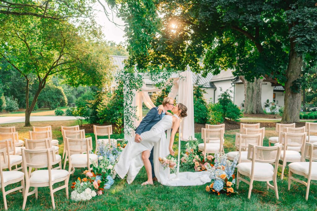 Bride and groom kiss after their outdoor ceremony at 1840 Manor House