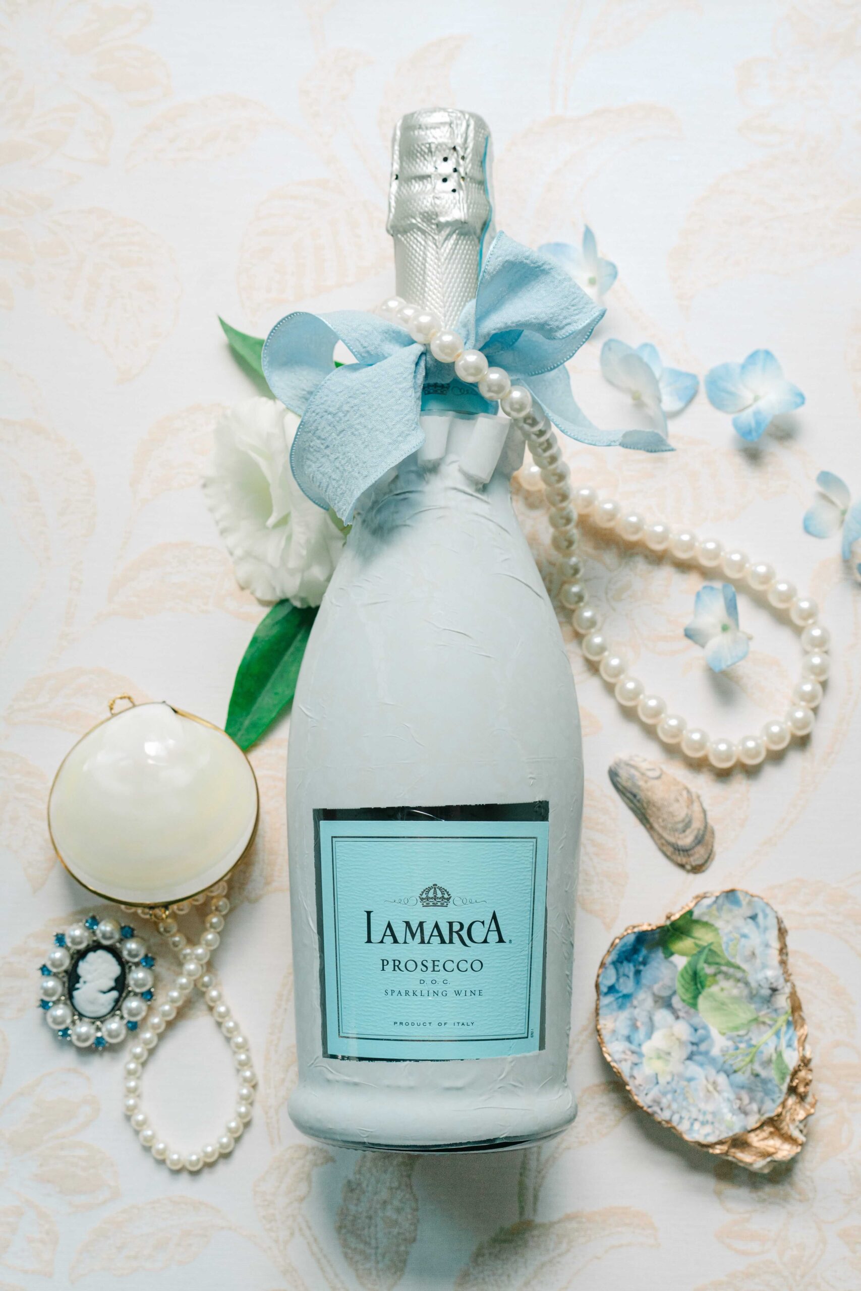 Details shot of prosecco and jewelry