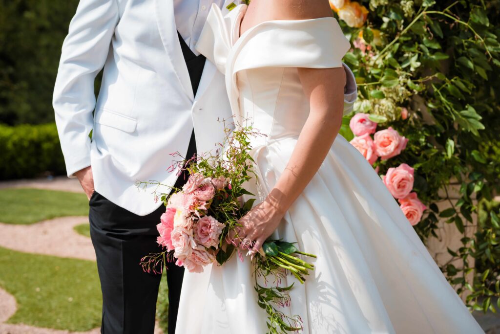 Elegant bridal gown and whimsical pink bouquet