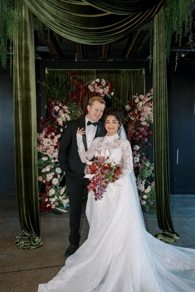 Bride and groom in front of their moody and dramatic wedding ceremony setup at Post 4 North 4th Corridor