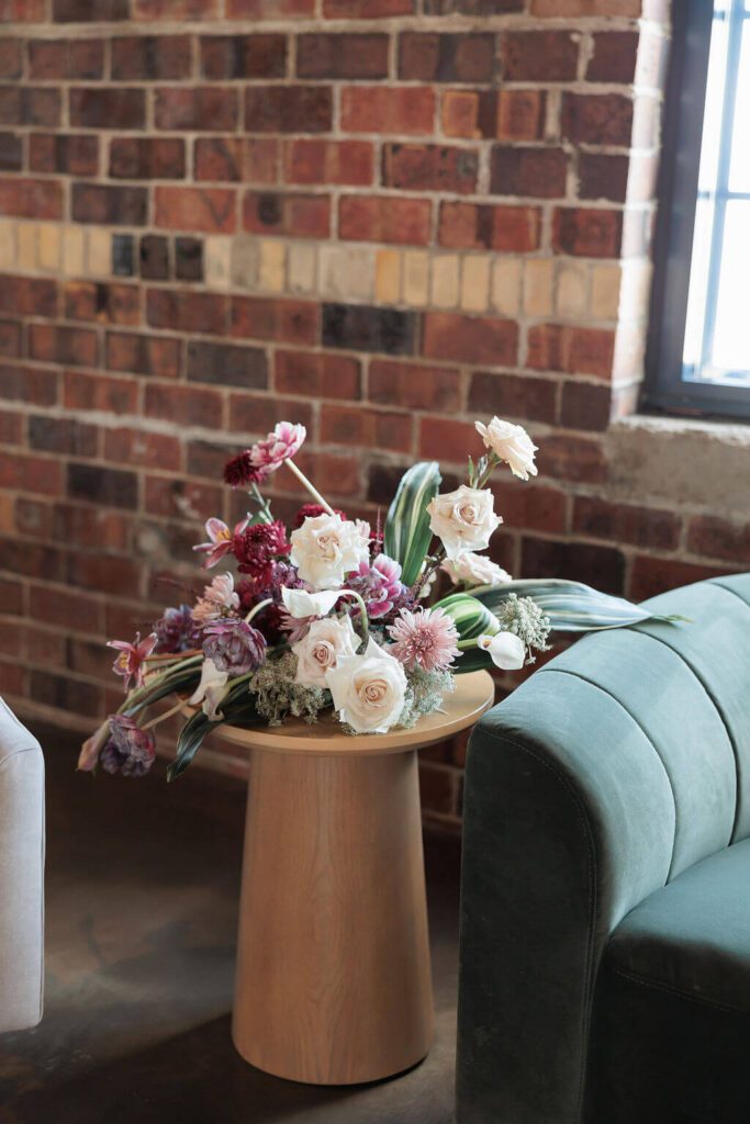 Wedding bouquet on an end table in a wedding reception lounge area