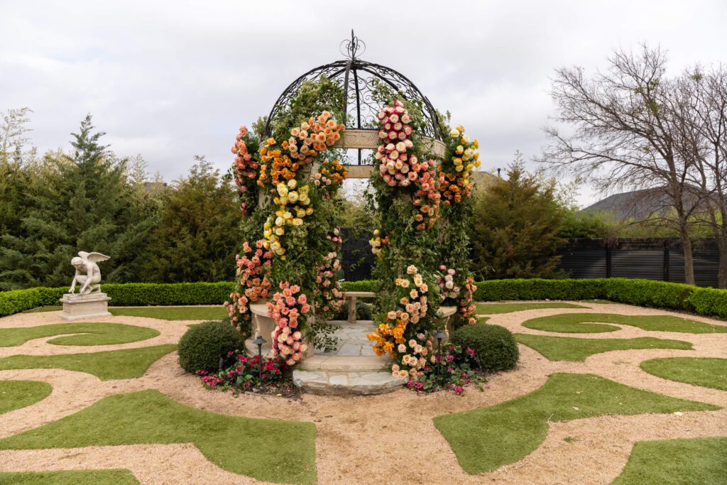 Knotting Hill Place garden gazebo decorated with pink, orange, and yellow florals