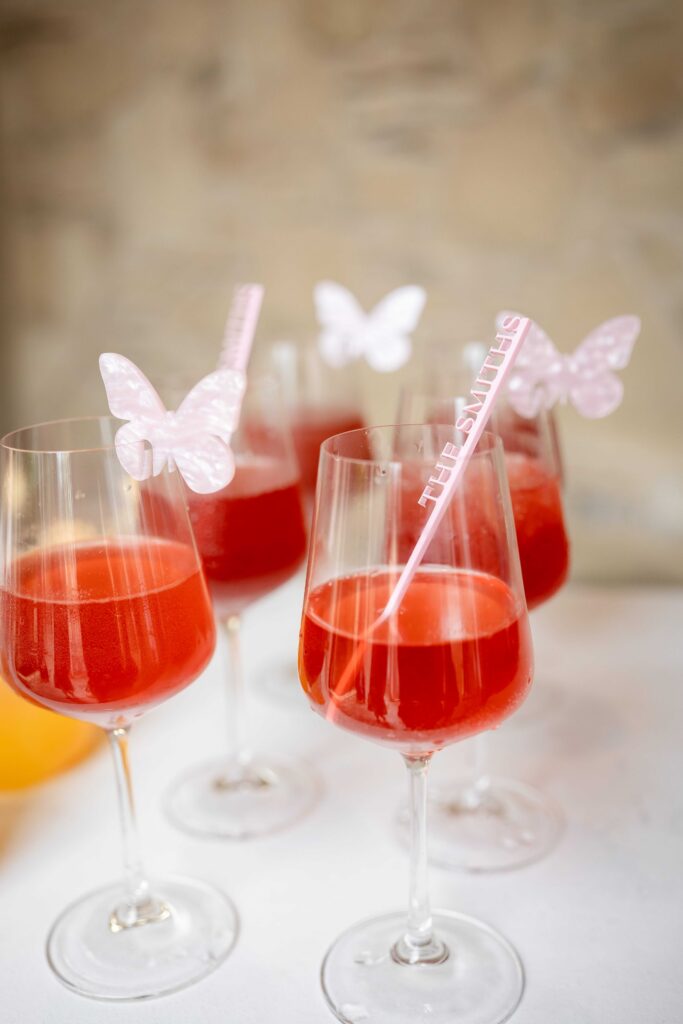 Cocktails with custom stir sticks and butterfly adornments