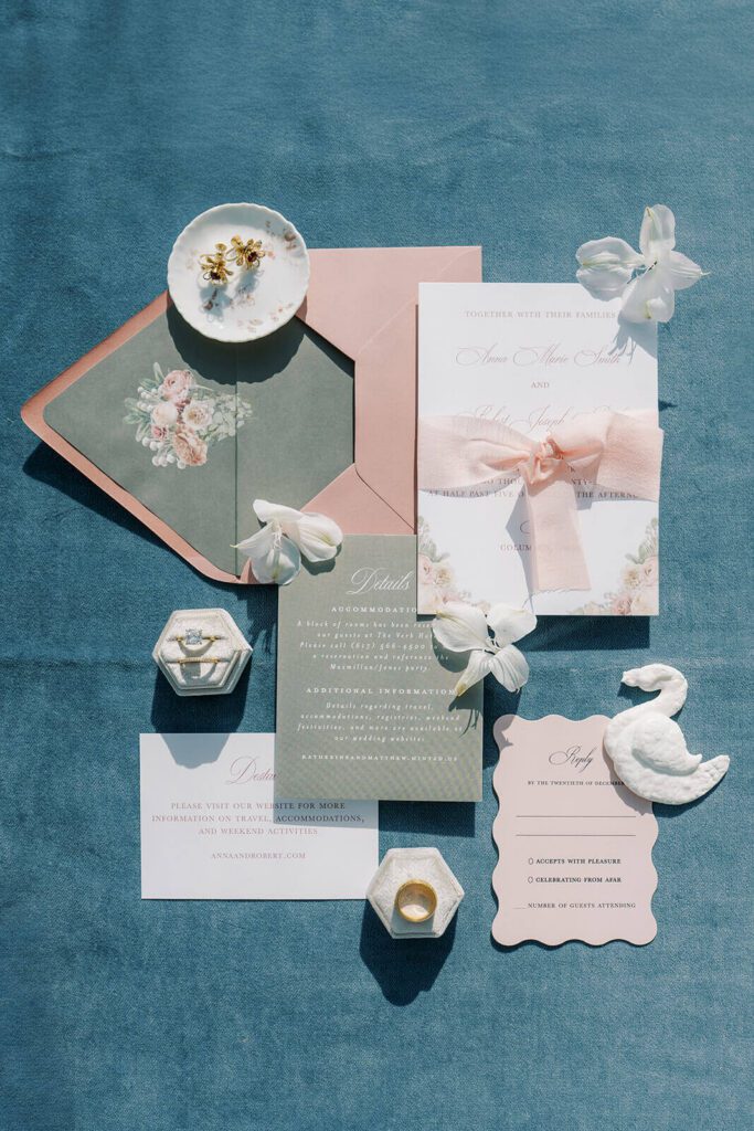 Whimsical and romantic wedding invitation suite in shades of pink, burgundy, and charcoal