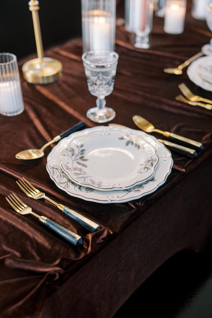Vintage floral plates with gold flatware for a wedding reception at Brick and Mortar Columbus