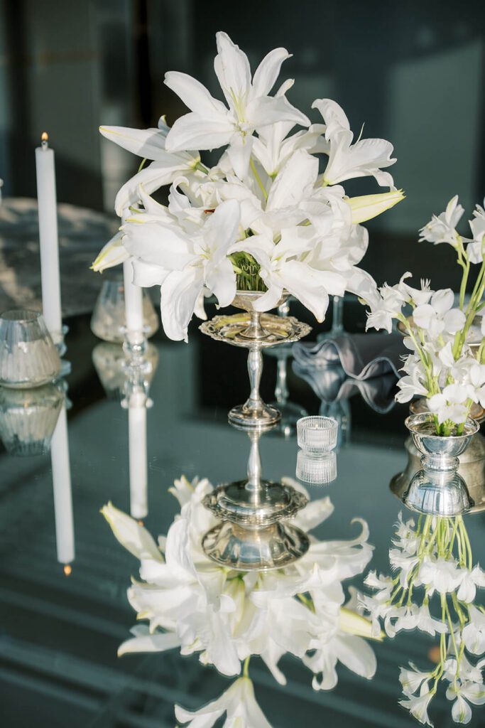 Lily floral arrangement on a mirrored surface