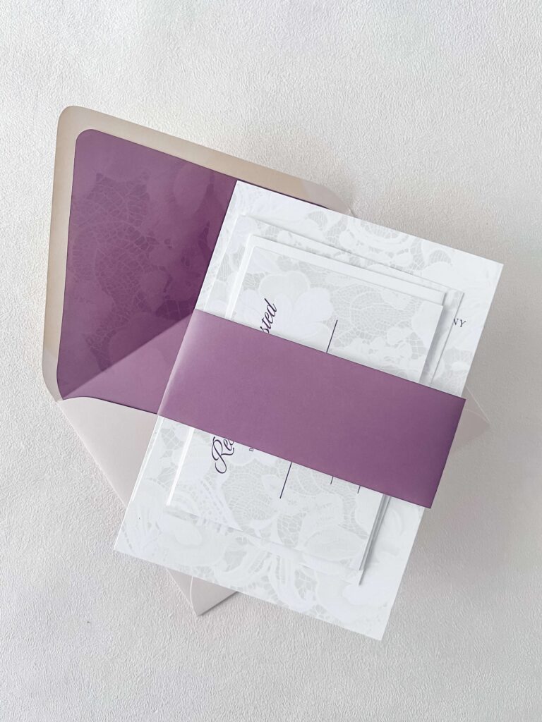 Romantic wedding invitation suite with purple belly band and purple envelope liner