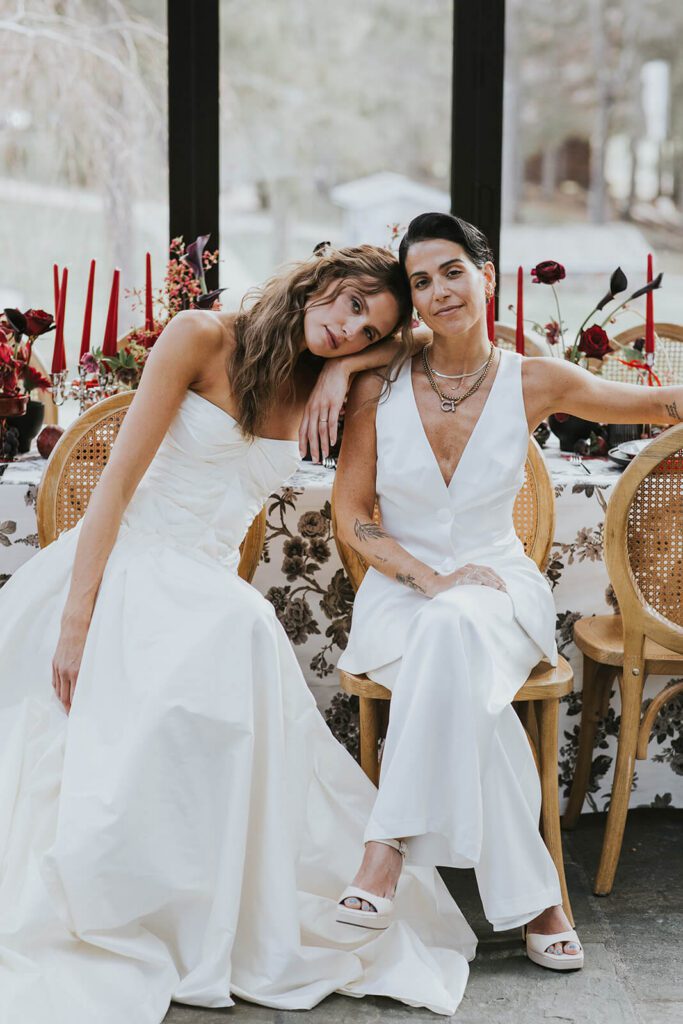 Two brides enjoy their Cedar Lakes Estate wedding reception in the Glasshouse