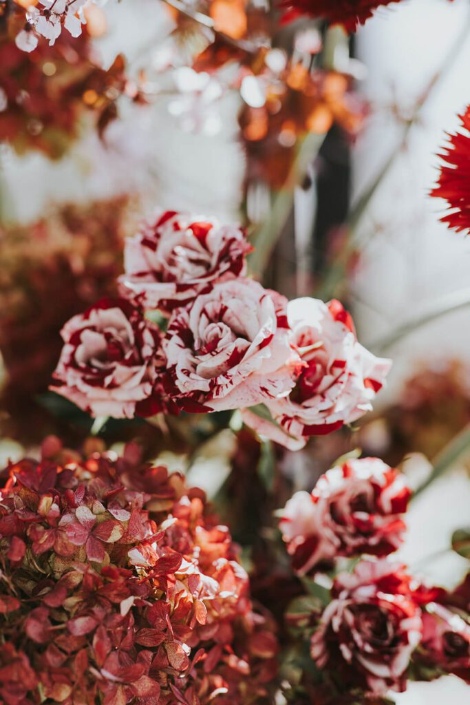 Shades of red floral arrangements for a wedding reception