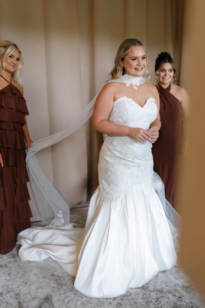 The bride seeing herself in her dress on her wedding day
