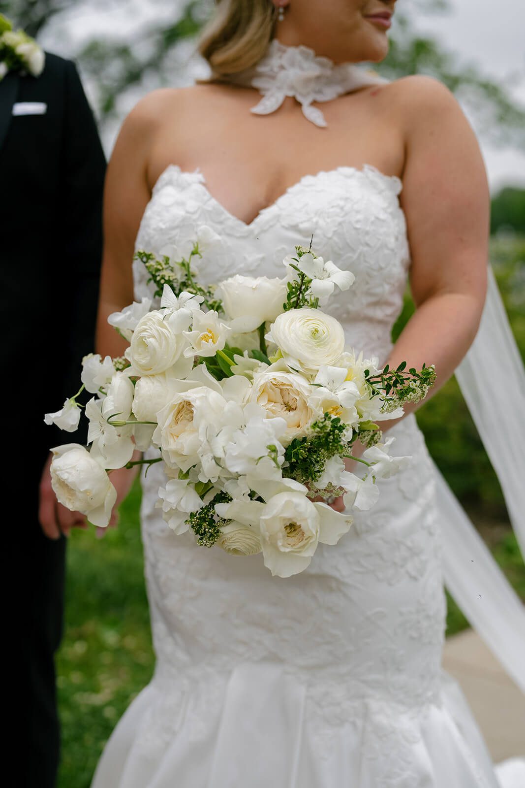 Bride holding a romantic white and green bouquet