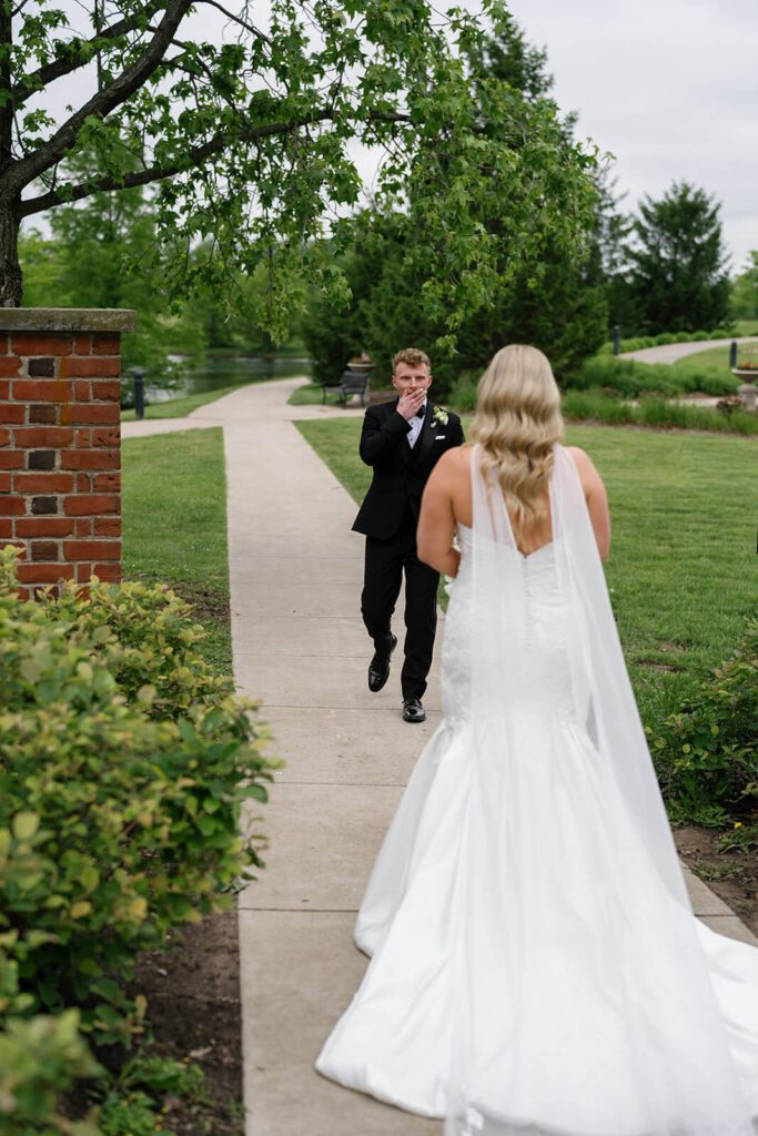 Groom sees the bride for the first look on their wedding day