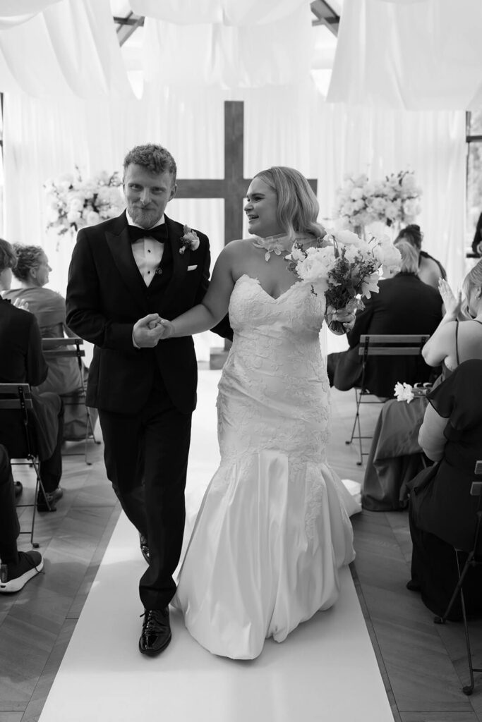 Bride and groom walking down the aisle after their wedding ceremony at The Montage Indianapolis