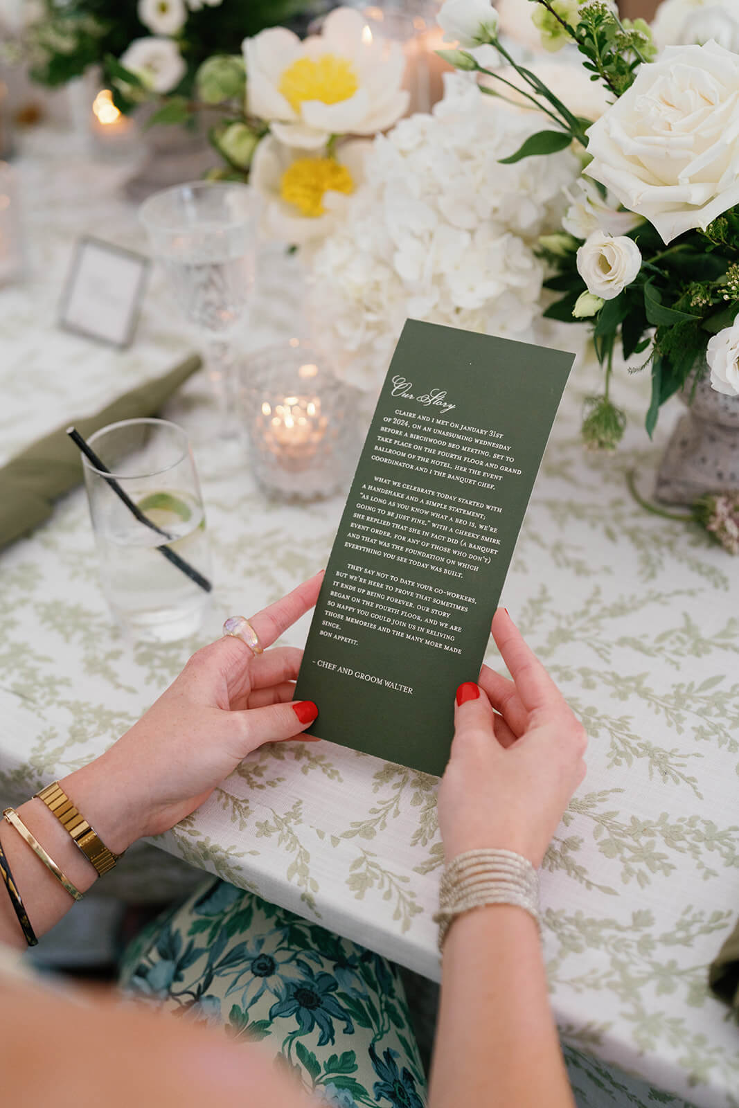 Guest holding wedding stationery outlining the couple's story about how they met