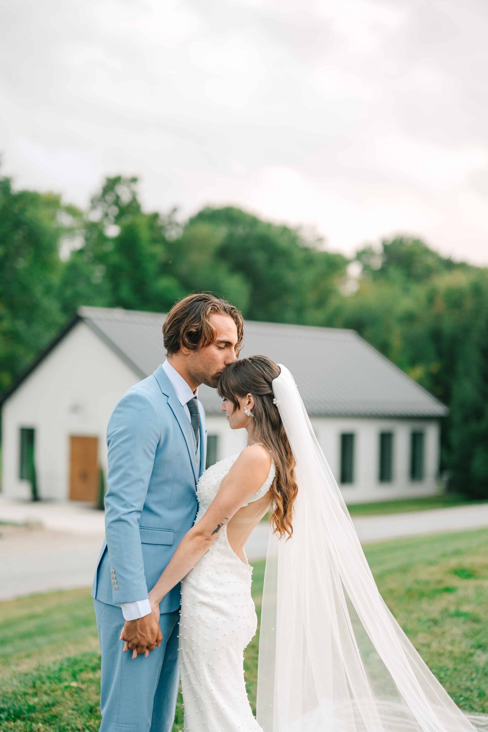Couple kissing outdoors at The Wellspring Ohio on their wedding day